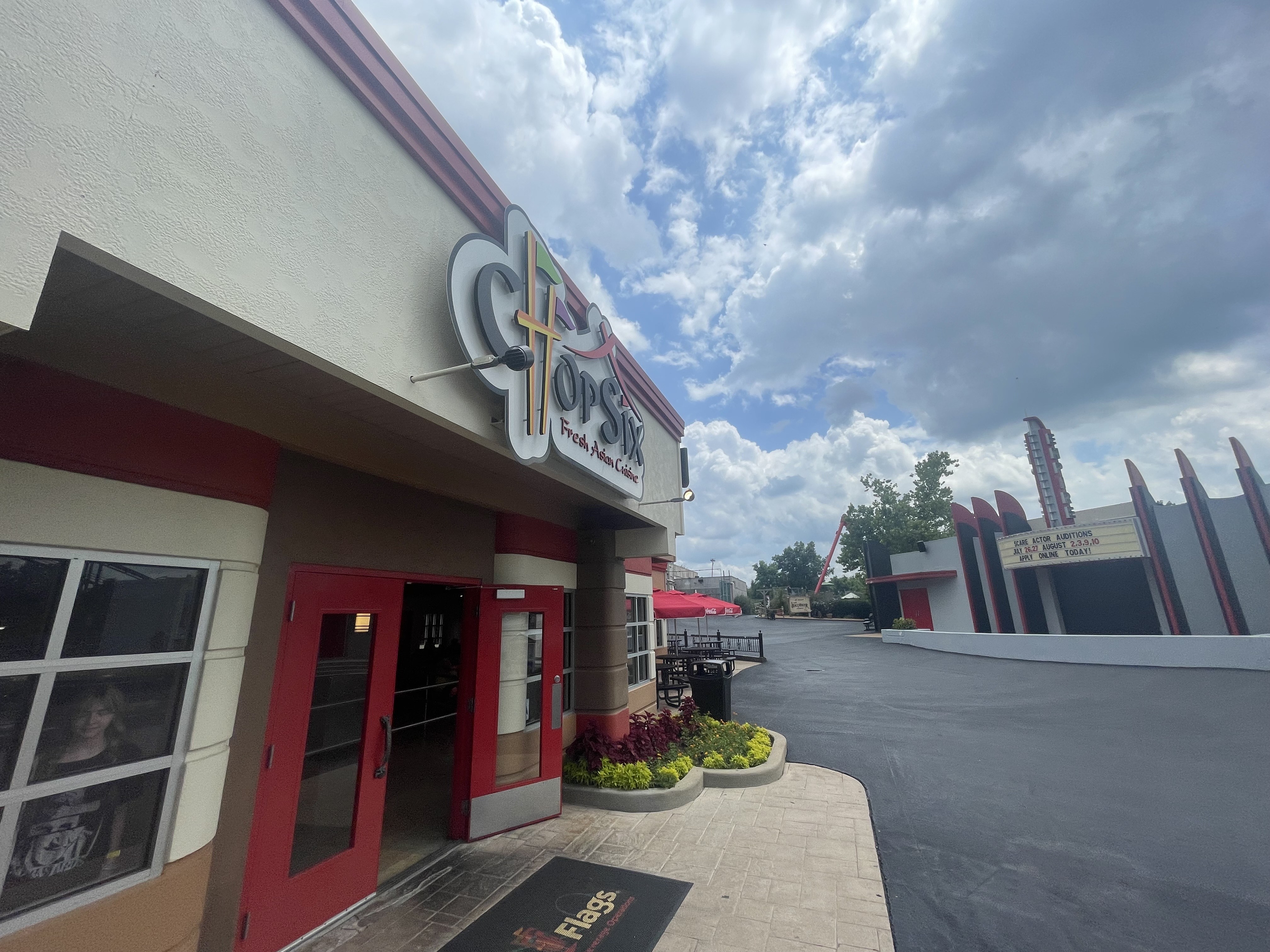 Wide angle photo of the Six Flags restaurant, Chop Six. Paisley is in the window of the establishment.