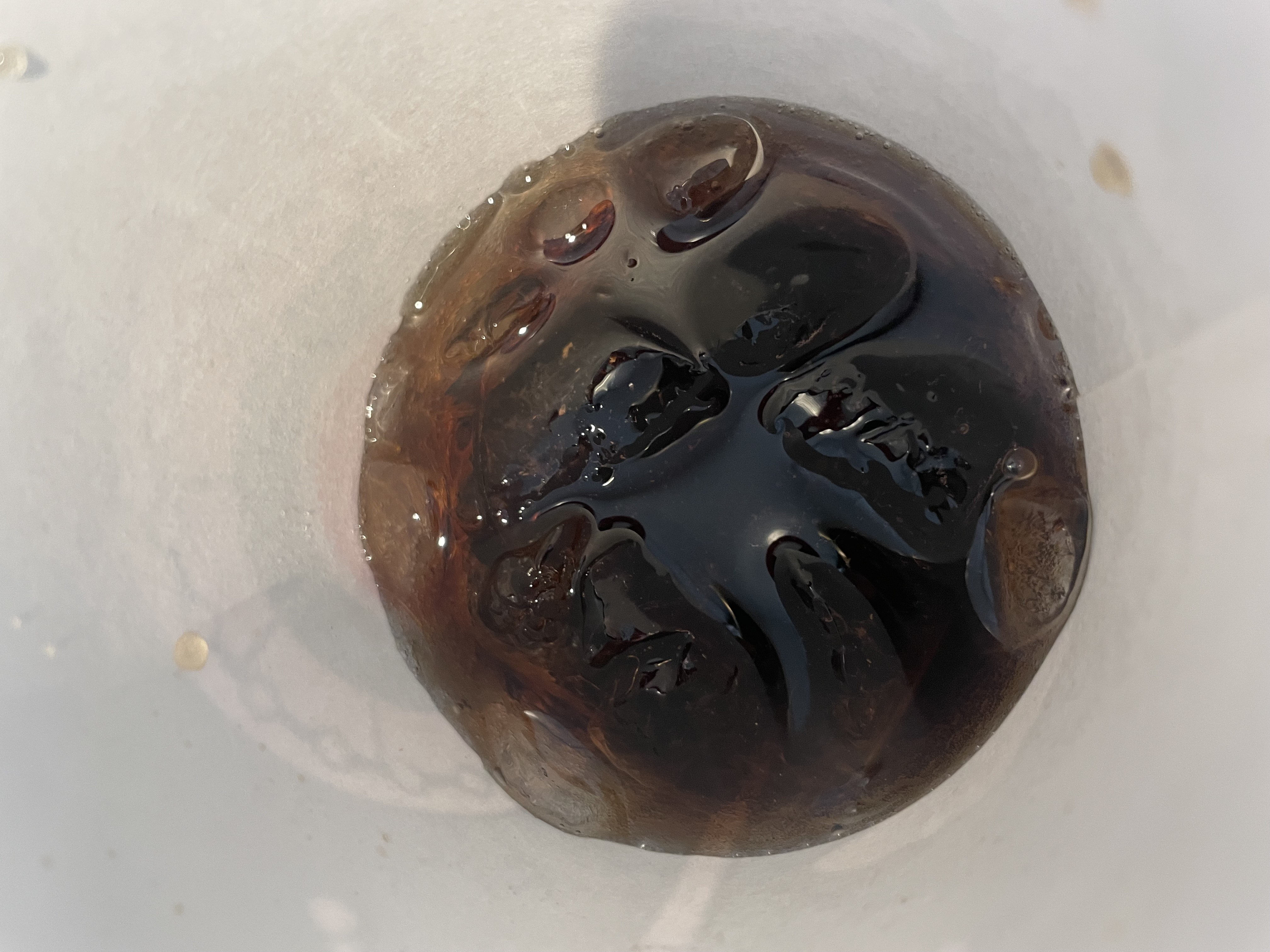 Soda in a paper cup.