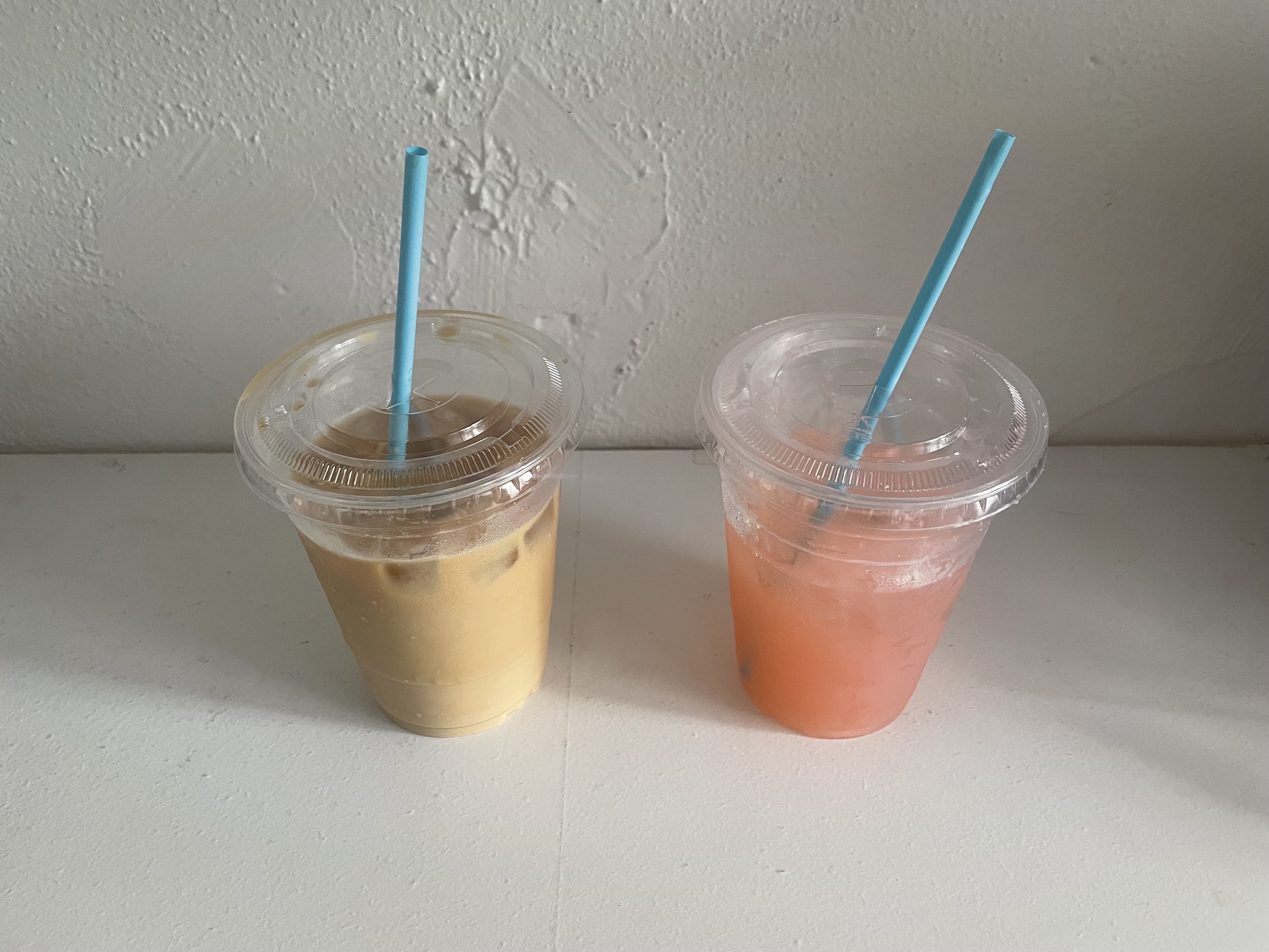 An iced coffee and a pink lemonade